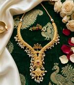 gold plated pearl necklace set with ruby and emerald accents