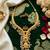gold plated pearl necklace set with ruby and emerald accents
