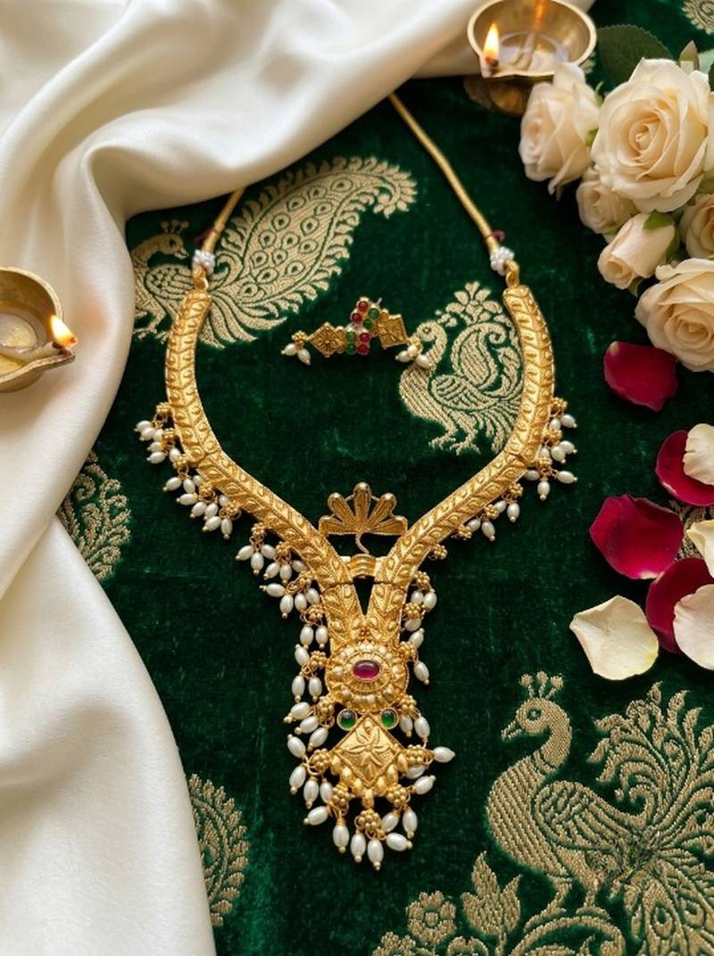 gold plated pearl necklace set with ruby and emerald accents