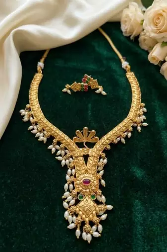 gold plated pearl necklace set with ruby and emerald accents