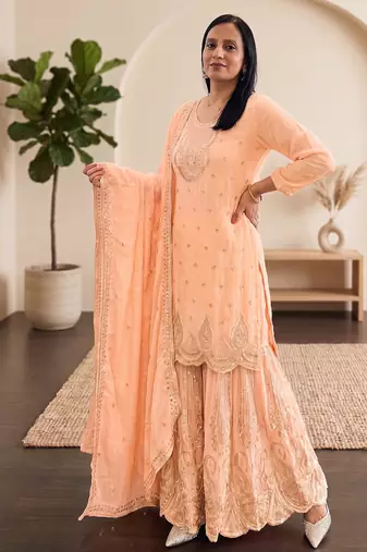 Pastel pink heavy zari work short kurti with flared sharara & dupatta