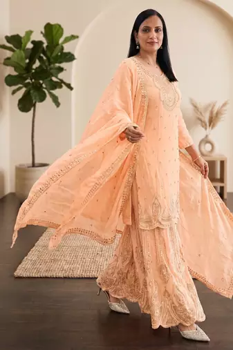 Pastel pink heavy zari work short kurti with flared sharara & dupatta