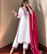 White heavy embroidered kurti pant set with contrast rani pink silk dupatta