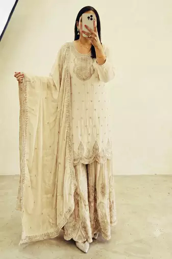 White heavy zari work short kurti with flared sharara & dupatta