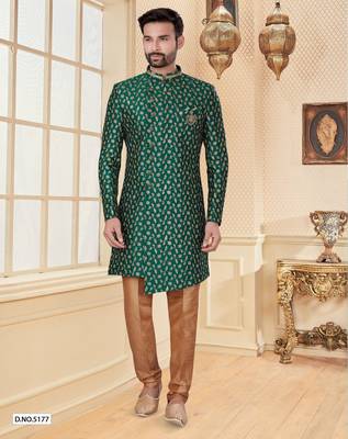 Green heavy jacquard sherwani set with full zari embroidery, minimal detailing, and fancy buttons. 1