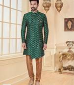 Green heavy jacquard sherwani set with full zari embroidery, minimal detailing, and fancy buttons.
