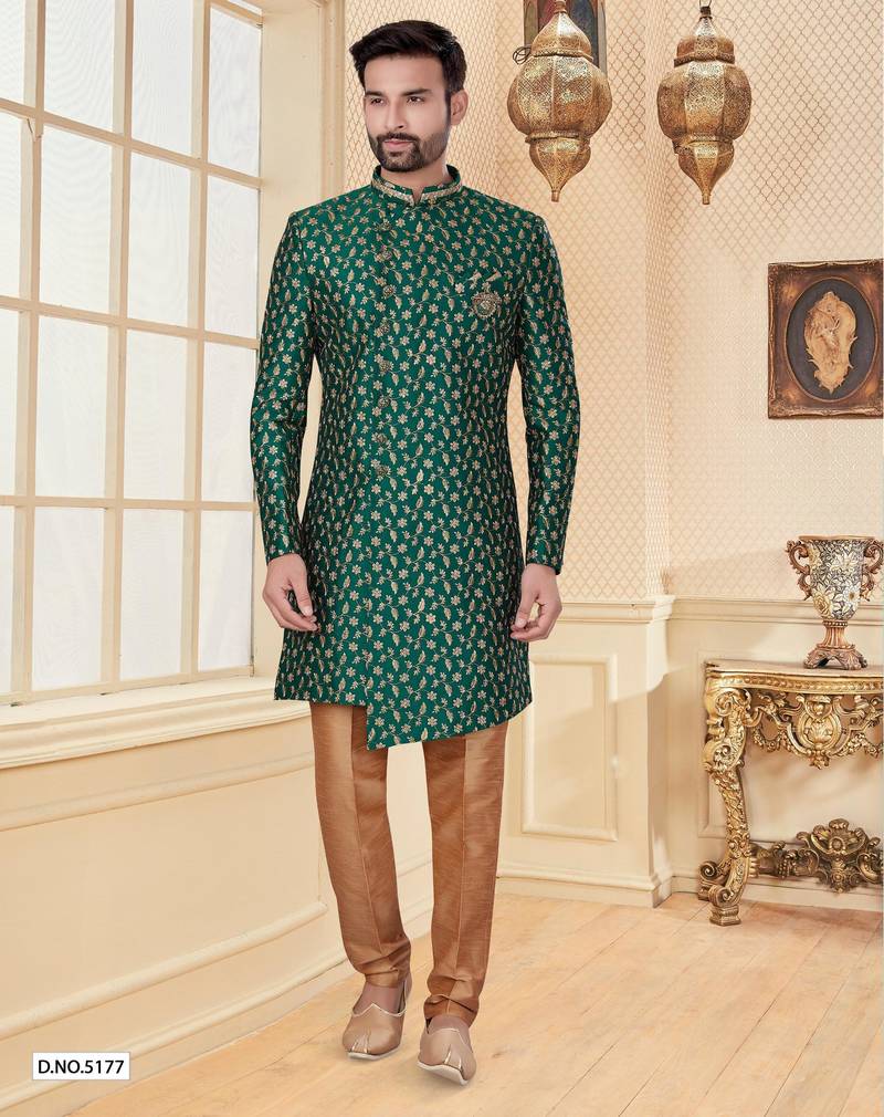Green heavy jacquard sherwani set with full zari embroidery, minimal detailing, and fancy buttons.