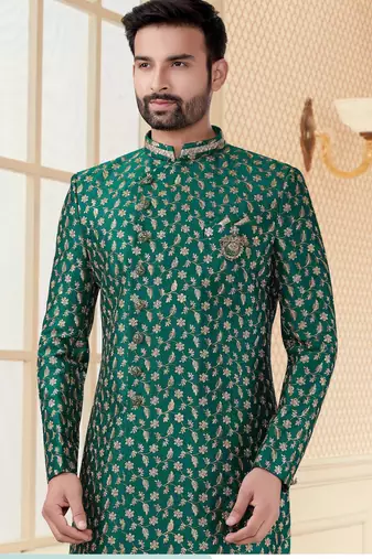 Green heavy jacquard sherwani set with full zari embroidery, minimal detailing, and fancy buttons.