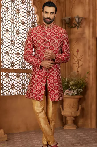 Maroon indo-western sherwani set with full computer embroidery, coloured buttons, and thread, lace, and stone work.