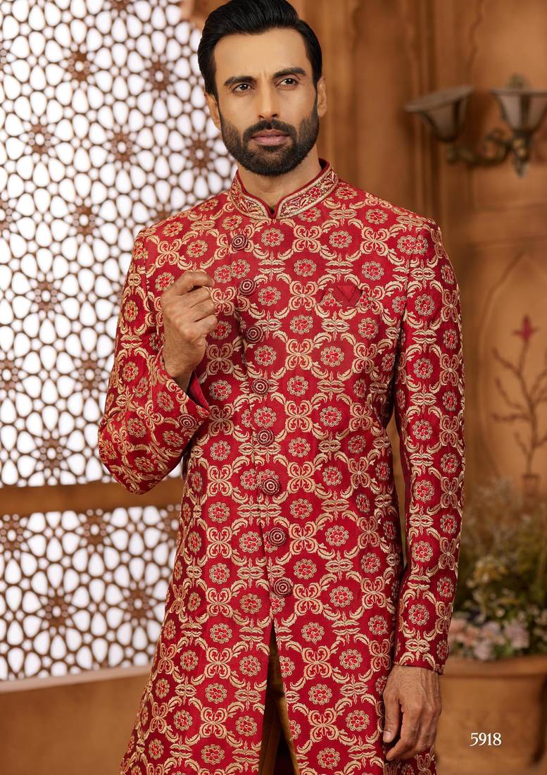 Maroon indo-western sherwani set with full computer embroidery, coloured buttons, and thread, lace, and stone work.