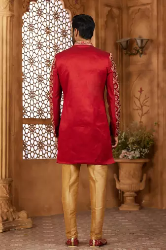 Maroon indo-western sherwani set with full computer embroidery, coloured buttons, and thread, lace, and stone work.