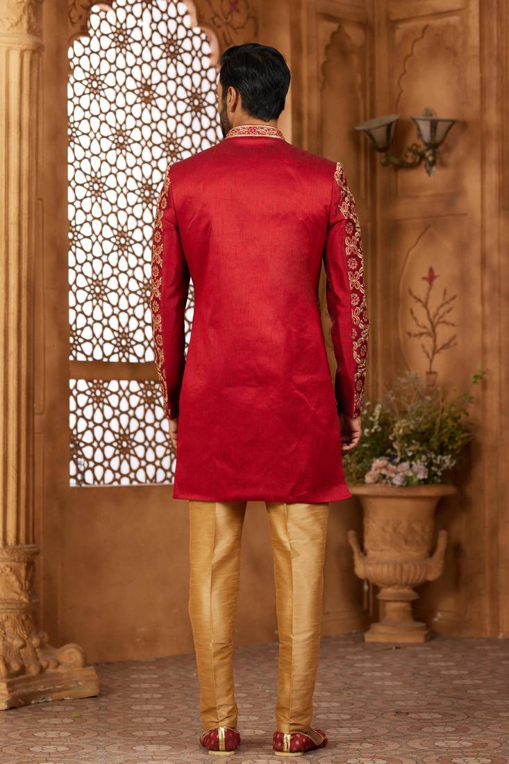 Maroon indo-western sherwani set with full computer embroidery, coloured buttons, and thread, lace, and stone work.