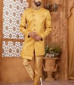 Gold indo-western sherwani set with full computer embroidery, coloured buttons, and thread, lace, and stone work.