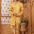 Gold indo-western sherwani set with full computer embroidery, coloured buttons, and thread, lace, and stone work.