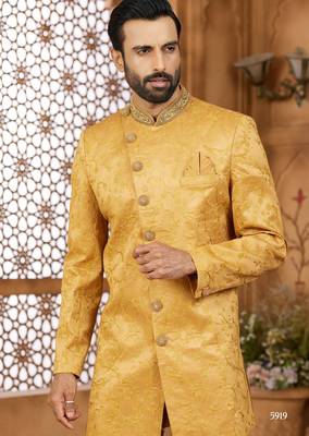 Gold indo-western sherwani set with full computer embroidery, coloured buttons, and thread, lace, and stone work. 2