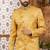 Gold indo-western sherwani set with full computer embroidery, coloured buttons, and thread, lace, and stone work.