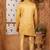 Gold indo-western sherwani set with full computer embroidery, coloured buttons, and thread, lace, and stone work.