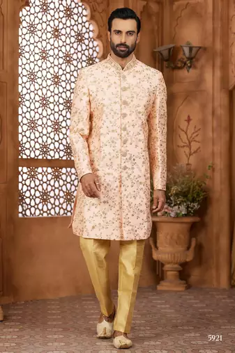 Peach indo-western sherwani set with full computer embroidery, coloured buttons, and thread, lace, and stone work.