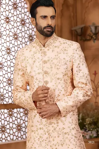 Peach indo-western sherwani set with full computer embroidery, coloured buttons, and thread, lace, and stone work.