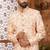 Peach indo-western sherwani set with full computer embroidery, coloured buttons, and thread, lace, and stone work.