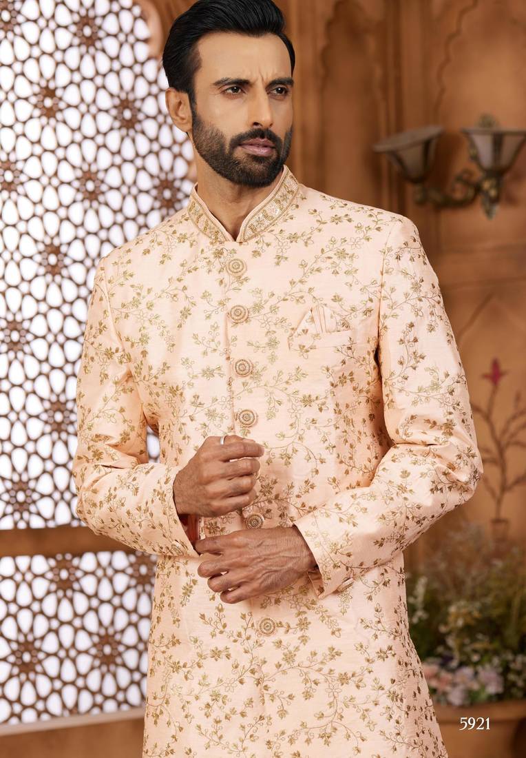 Peach indo-western sherwani set with full computer embroidery, coloured buttons, and thread, lace, and stone work.