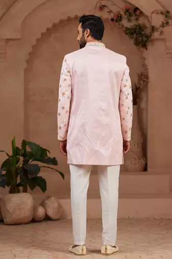 Light pink indo-western sherwani set with full computer embroidery, coloured buttons, and thread, lace, and stone work.