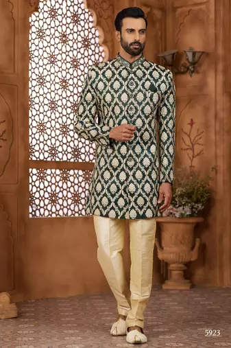 Green indo-western sherwani set with full computer embroidery, coloured buttons, and thread, lace, and stone work.