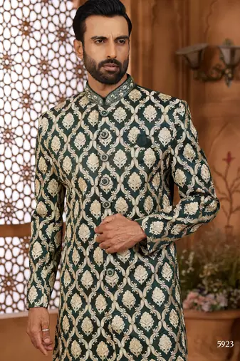 Green indo-western sherwani set with full computer embroidery, coloured buttons, and thread, lace, and stone work.