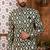 Green indo-western sherwani set with full computer embroidery, coloured buttons, and thread, lace, and stone work.