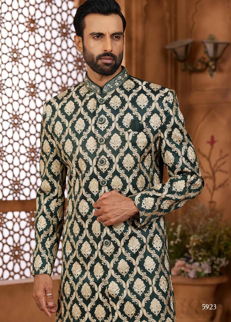 Green indo-western sherwani set with full computer embroidery, coloured buttons, and thread, lace, and stone work.