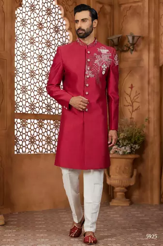 Red indo-western sherwani set with full computer embroidery, coloured buttons, and thread, lace, and stone work.