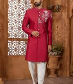 Red indo-western sherwani set with full computer embroidery, coloured buttons, and thread, lace, and stone work.