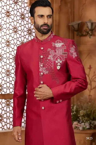 Red indo-western sherwani set with full computer embroidery, coloured buttons, and thread, lace, and stone work.