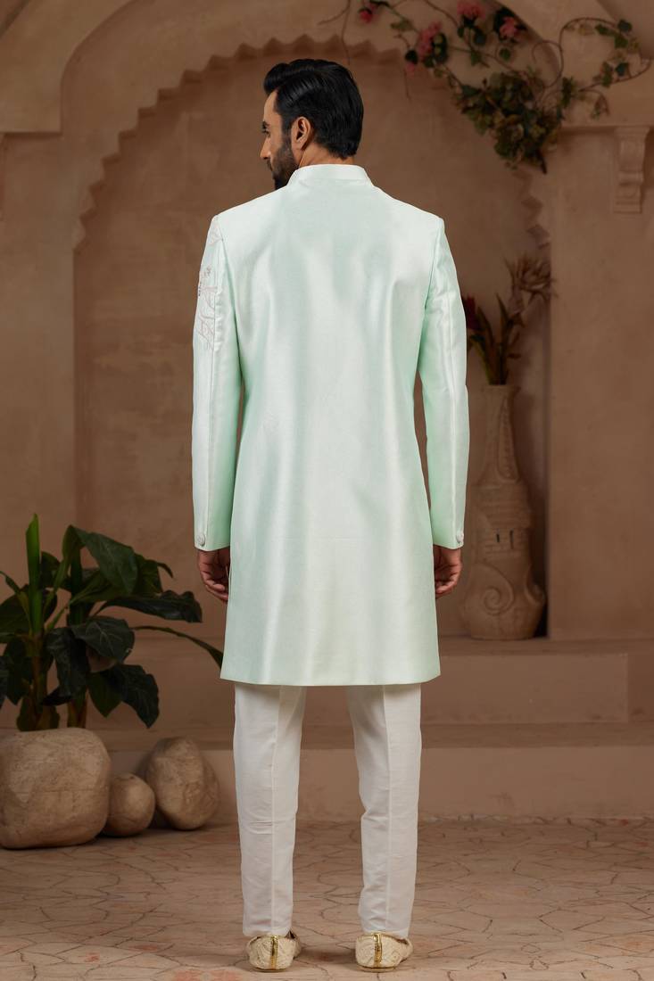 Mint green classic indo-western sherwani set with handwork on neck & buttons,resham thread, stone & beads work.