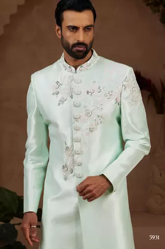 Mint green classic indo-western sherwani set with handwork on neck & buttons,resham thread, stone & beads work.