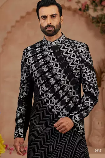 Black classic velvet indo-western sherwani set with full computer embroidery, thread and star work, and fancy buttons.