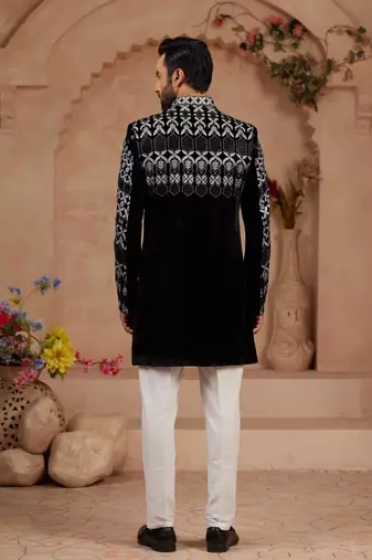 Black classic velvet indo-western sherwani set with full computer embroidery, thread and star work, and fancy buttons.