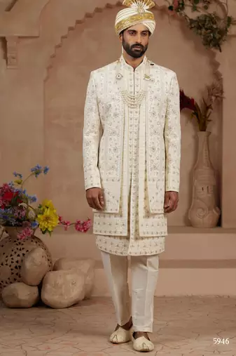Cream heavy sherwani three-piece set with full hand embroidery, stone work, and resham thread detailing.