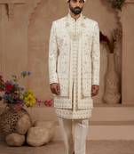 Cream heavy sherwani three-piece set with full hand embroidery, stone work, and resham thread detailing.