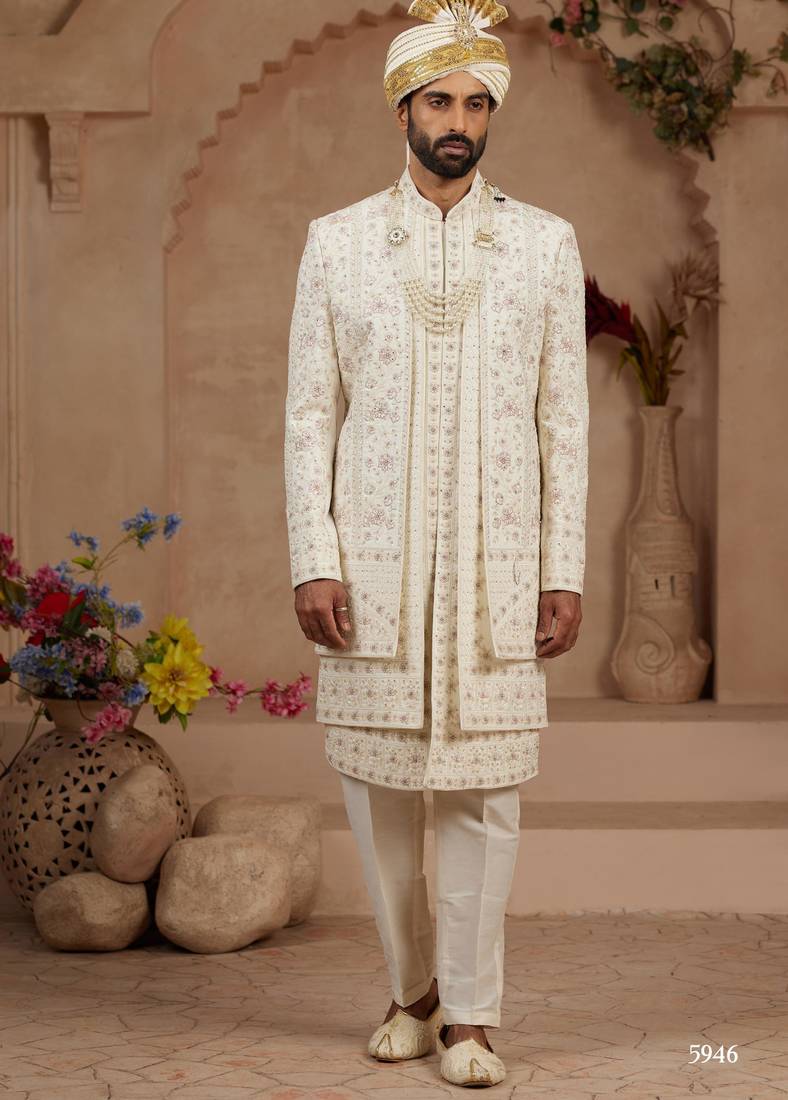 Cream heavy sherwani three-piece set with full hand embroidery, stone work, and resham thread detailing.