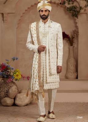Cream heavy sherwani three-piece set with full hand embroidery, stone work, and resham thread detailing. 2