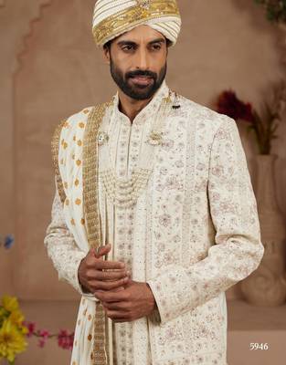 Cream heavy sherwani three-piece set with full hand embroidery, stone work, and resham thread detailing. 3