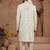 Cream heavy sherwani three-piece set with full hand embroidery, stone work, and resham thread detailing.