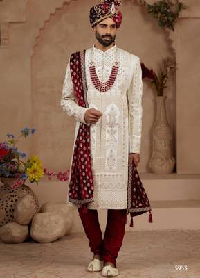 Cream heavy sherwani set with full hand embroidery, stone work, and resham thread detailing. 1