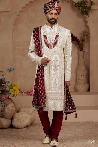 Cream heavy sherwani set with full hand embroidery, stone work, and resham thread detailing.