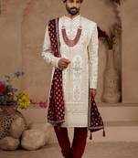 Cream heavy sherwani set with full hand embroidery, stone work, and resham thread detailing.