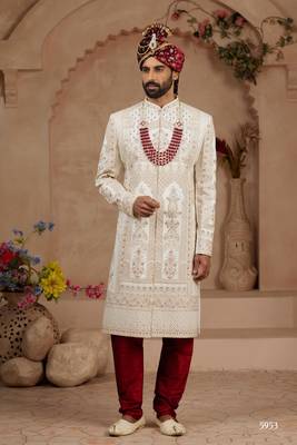 Cream heavy sherwani set with full hand embroidery, stone work, and resham thread detailing. 2