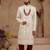Cream heavy sherwani set with full hand embroidery, stone work, and resham thread detailing.