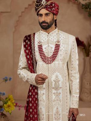 Cream heavy sherwani set with full hand embroidery, stone work, and resham thread detailing. 3
