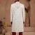 Cream heavy sherwani set with full hand embroidery, stone work, and resham thread detailing.